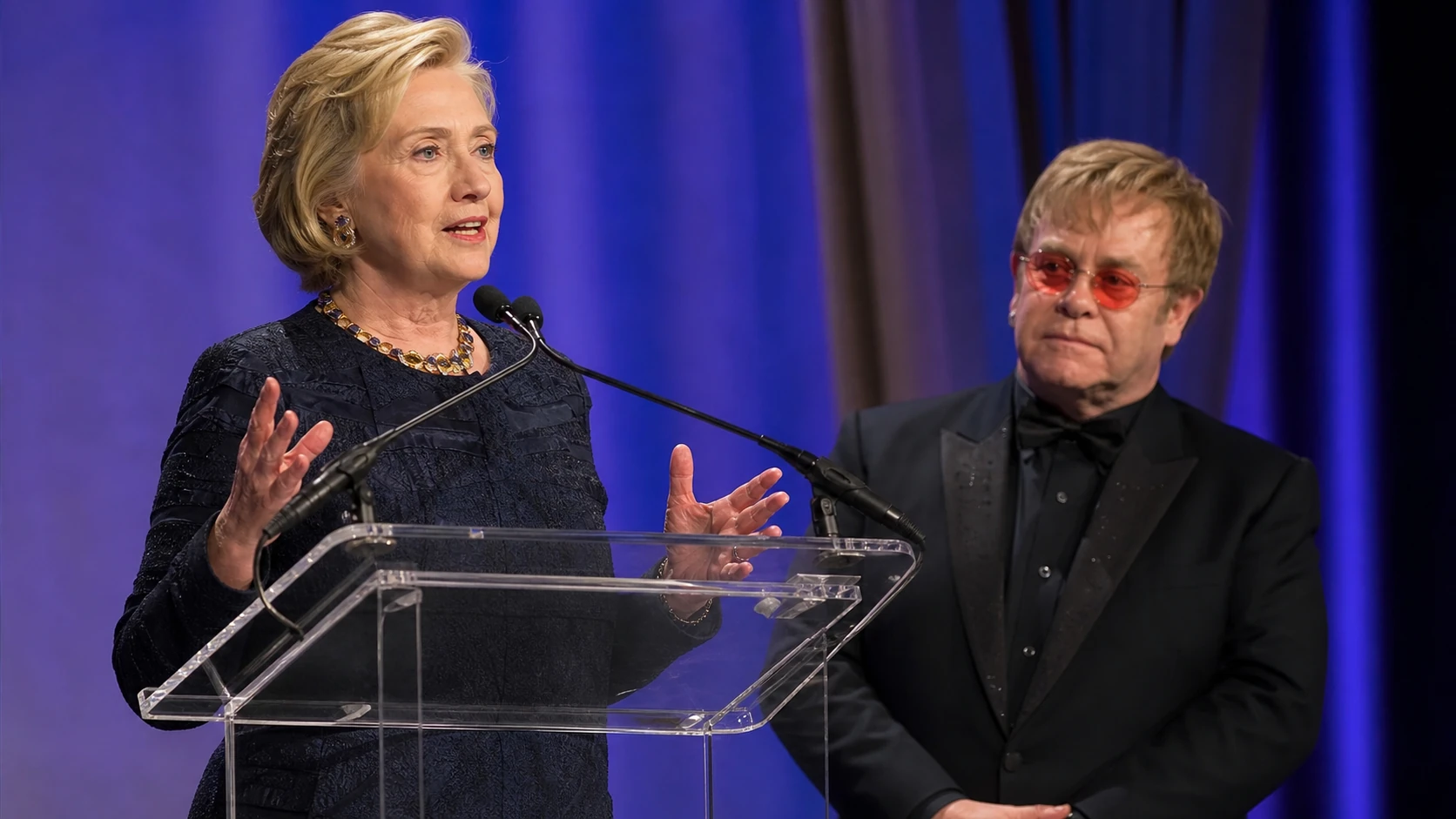 Hillary Clinton’s Connection to the Elton John AIDS Foundation - elton john and hillary clinton